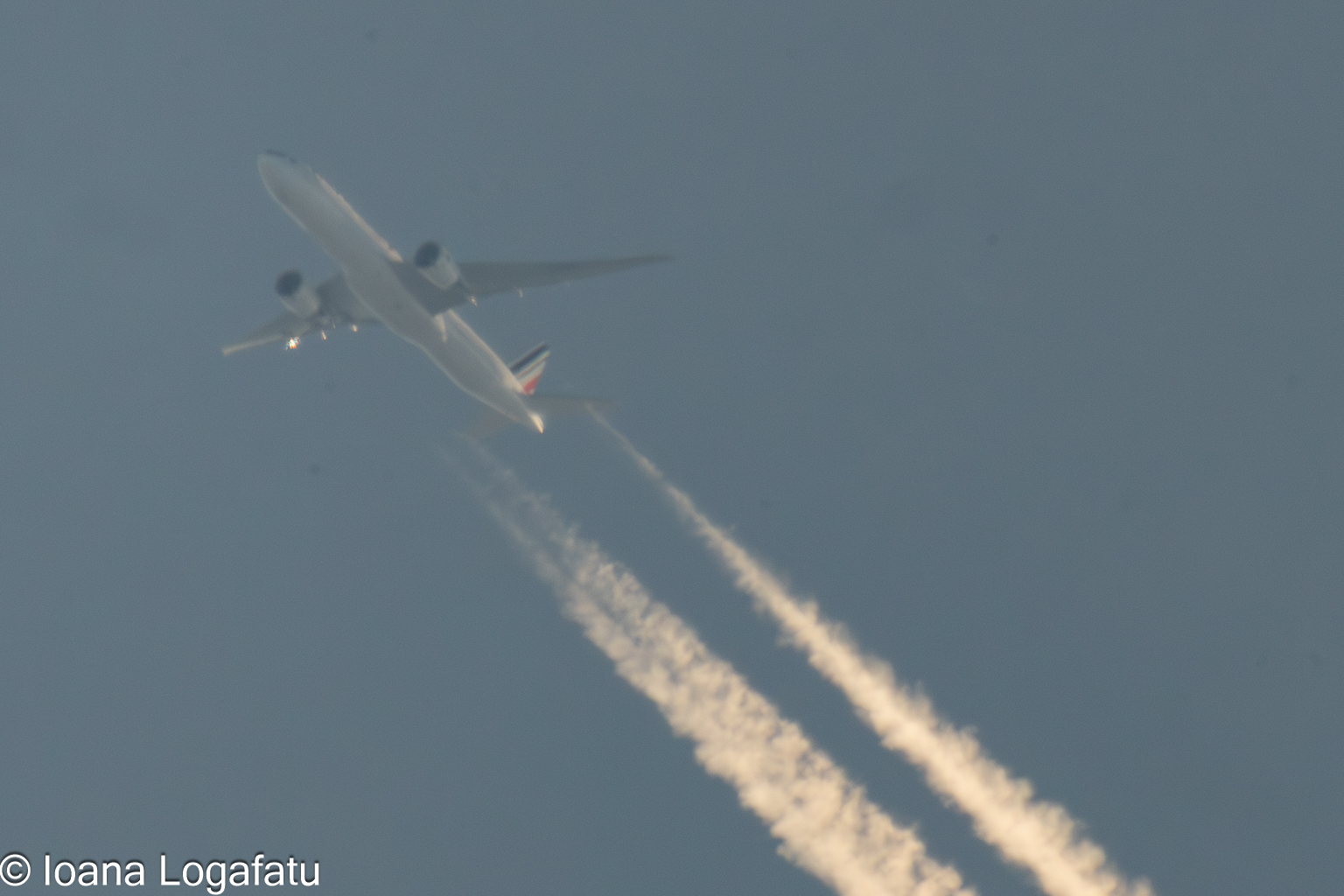 Airplane soaring through a clear blue sky